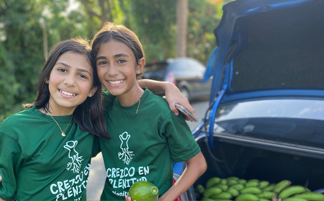 Two smiling girls hugging each other