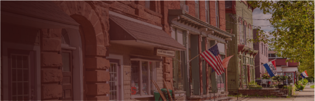 American flag displayed on the front of a building, symbolizing community and stability for the FHLBNY 2025 Report to Members