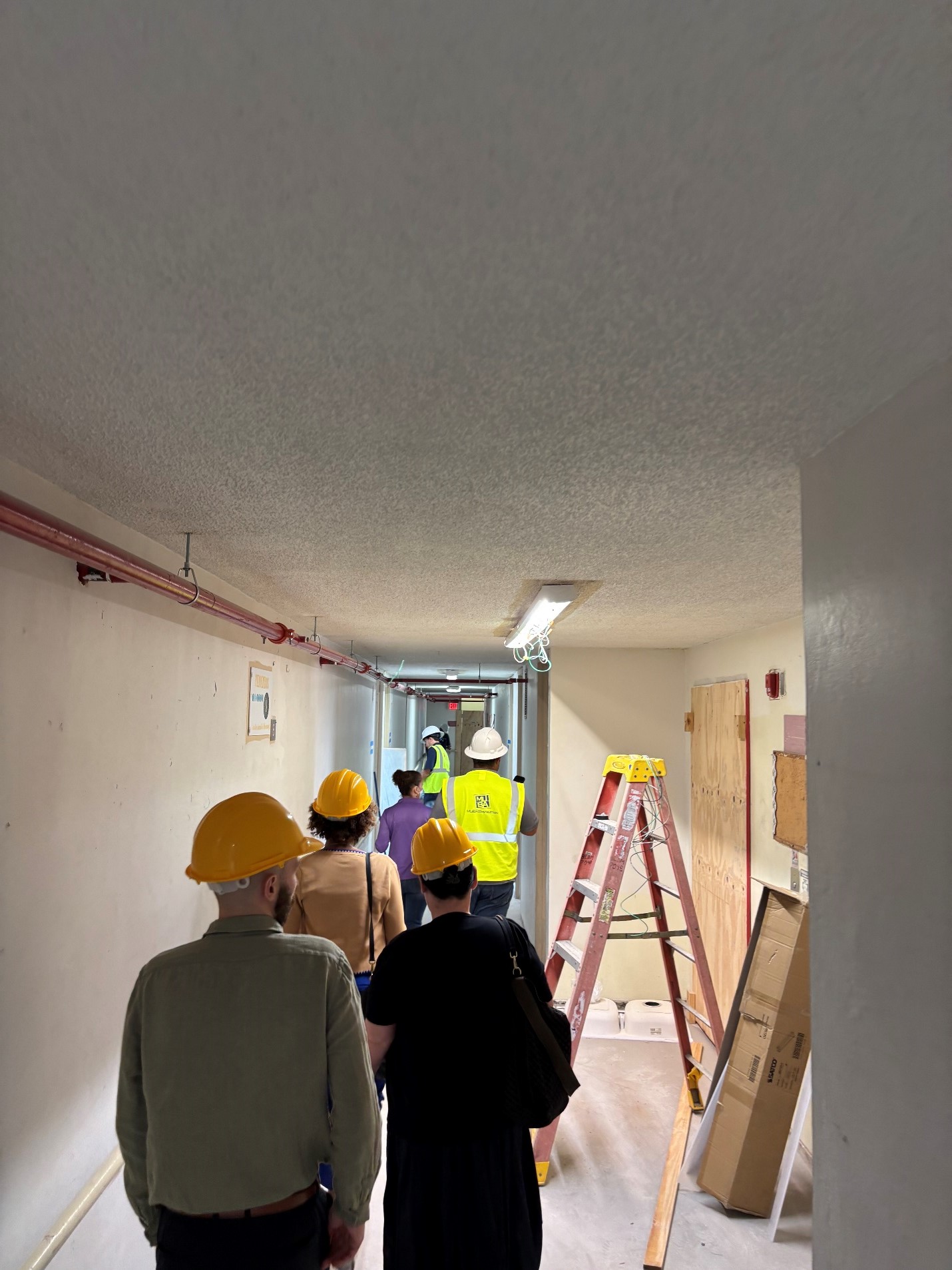 FHLBNY team touring inside of Santa Juanita's building